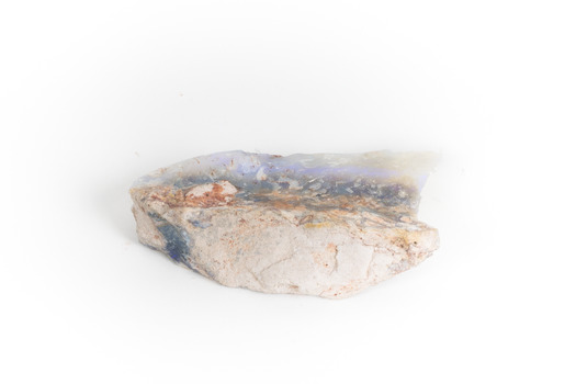 A mineraloid specimen which has a light blue "play-of-colour" in the centre 