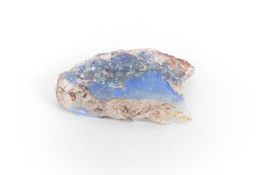 A mineraloid specimen which has a light blue "play-of-colour" in the centre 