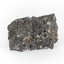 A smaller than hand sized rock specimen which is dark grey in colour with small holes and white deposits across its surface.