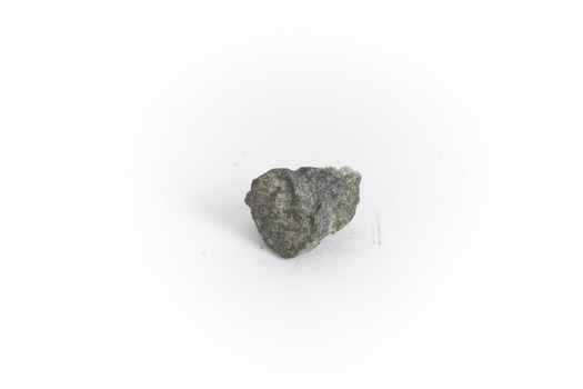 A small gold-sulphide ore mineral specimen in shades of silver and grey with flecks of gold