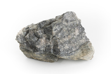 A hand-sized solid mineral specimen in shades of grey and white tinged with yellow near the bottom