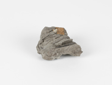 A hand-sized solid mineral specimen in shades of grey and brown