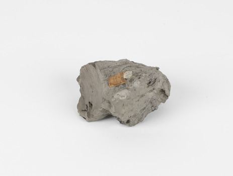 A hand-sized solid mineral specimen in shades of grey and brown