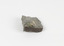 A disfigured rectangular like shape of fine-grained, poorly foliated, porphyroblastic metamorphic rock. The spotted slate is light grey in colour with darker flecks throughout.