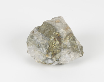 A small round geological specimen with some jagged and hard edges. The colouring is white with dark veins and some gold-like deposits. There is an existing label with the number 104.