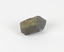 An angular, hand sized grey geological specimen in white spotted grey colours, with one flat brown side.