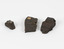 Three block pieces of dark chocolate brown and grey organic matter. The middle of the three has a tag affixed on the flat top surface which has the number 245 written on it.