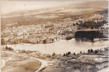 Black and white aerial photograph of a lake and surrounding landscape
