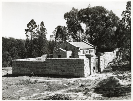 Outside fence view of Powder Magazine Beechworth with partial open gate