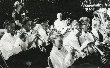Black and white photograph depicting a band playing various types of instruments. All band members are dressed in formal attire.