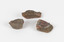 The image shows three pieces of stone with a russet interior hue and a grey/brown porous crust. 