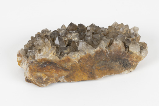 A large hand-sized copper mineral in shades of brown and gray