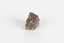 A palm-sized uncut mineraloid specimen in shades of brown, orange, and white.