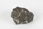 Hand-sized piece of pale pink mineral specimen with dark grey rim and hollowed centre. 
