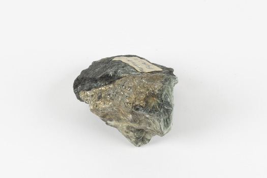 A small-medium-sized solid specimen containing two minerals with shades of black/grey, brassy gold, green, and white