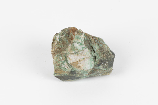 Small mineral specimen in shades of white, green, orange and gray