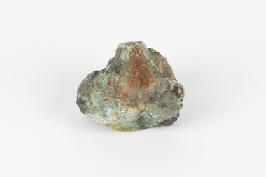Small mineral specimen in shades of orange, green, brown and black.
