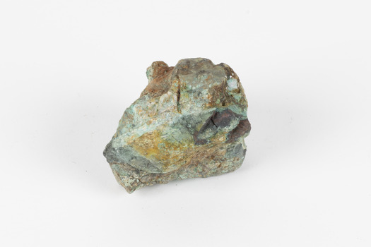 Small mineral specimen in shades of white, green, orange and gray