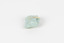 A palm-sized mineral specimen in shades of blue-green with white veining.