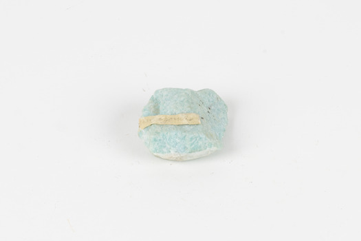 A palm-sized mineral specimen in shades of blue-green with white veining.
