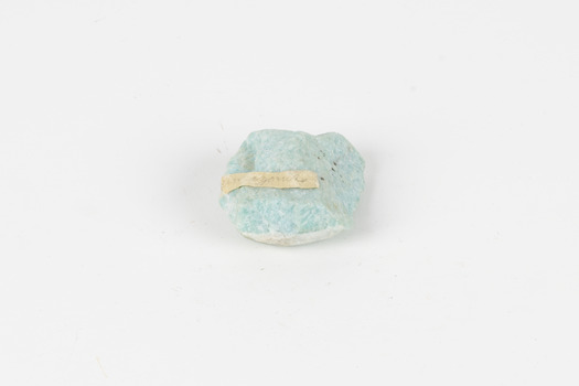 A palm-sized mineral specimen in shades of blue-green with white veining.