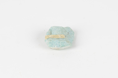 A palm-sized mineral specimen in shades of blue-green with white veining.