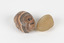 The photograph shows one larger piece of Agate in shades of peach and grey and a smaller piece of orange quartz. 