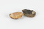 Two egg-sized solid mineral specimens displaying light and dark brown matrix and peach/orange toned agate. 