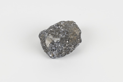 A small-sized solid specimen containing one mineral with a sparkly silver metallic lustre exterior and pastel-grey interior.