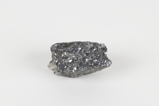 A small-sized solid specimen containing one mineral with a sparkly silver metallic lustre exterior and pastel-grey interior.