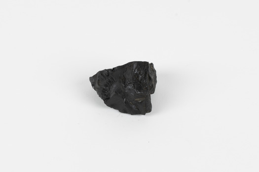 A hand-sized solid specimen containing one mineral with a black/steel-grey metallic lustre.