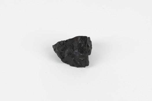 A hand-sized solid specimen containing one mineral with a black/steel-grey metallic lustre.