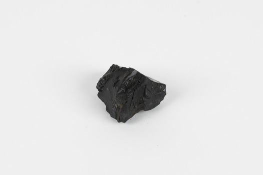 A hand-sized solid specimen containing one mineral with a black/steel-grey metallic lustre.