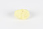 A small solid crystalline mineral specimen that is largely light yellow, with one darker spot. 
