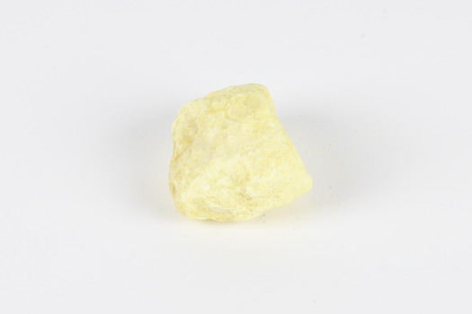 A small solid crystalline mineral specimen that is largely light yellow, with some darkening on right side. 