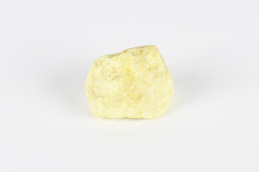 A small solid crystalline mineral specimen that is largely light yellow, with some darkening near top. 
