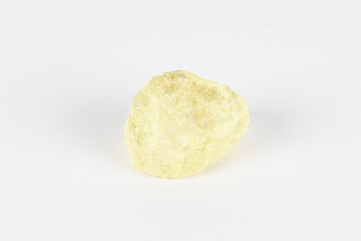 A small solid crystalline mineral specimen that is largely light yellow, with some darkening near top. 