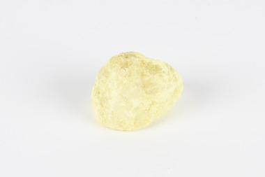 A small solid crystalline mineral specimen that is largely light yellow, with some darkening near top. 