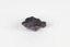 Image shows a medium-sized piece of rough gemstone with a purple interior and dark grey exterior crust. 