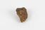 a palm-sized solid mineral specimen in shades of brown, orange and grey