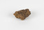 a palm-sized solid mineral specimen in shades of brown, orange and grey