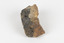 A fist-sized solid geological specimen. Each half is made of a different material, one side is cream and orange/brown coloured, the other side is dark grey
