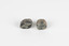 Two pieces of separate mineral specimen in shades of grey, brown, and yellow with crosses in the center
