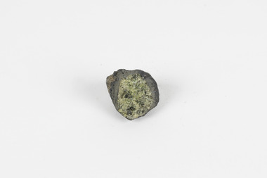 A solid mineral specimen in shades of green, grey and brown with the centre of the mineral exposed