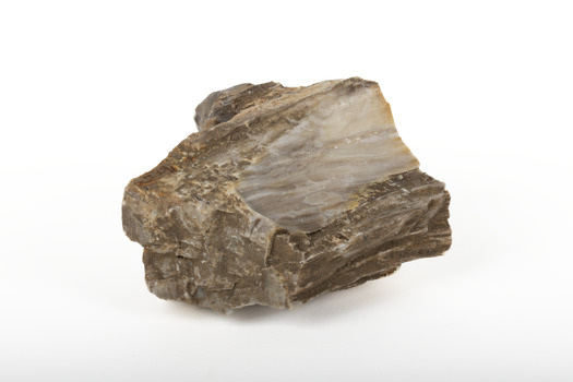 A solid mineral in shades of brown, white, and beige