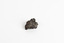 A small, palm-sized solid mineral specimen with shades of browns, black and copper tones