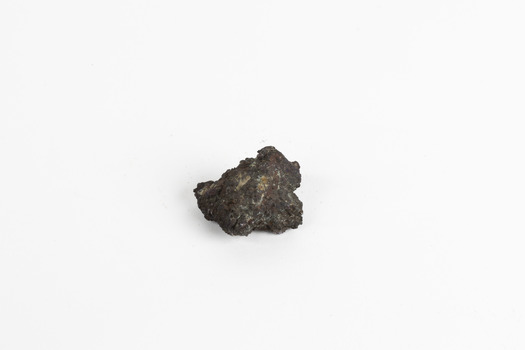 A small, palm-sized solid mineral specimen with shades of browns, black and copper tones