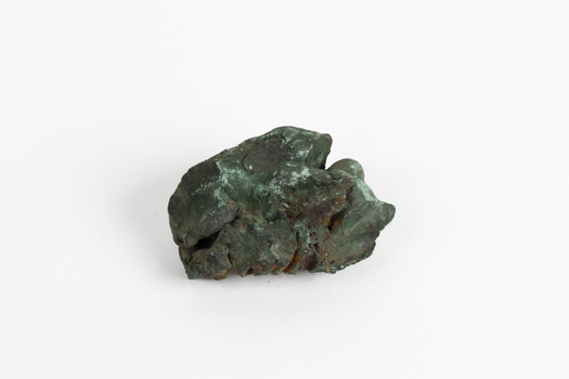 A hand-sized solid mineral specimen in shades of blue, green and copper.