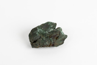 A hand-sized solid mineral specimen in shades of blue, green and copper.