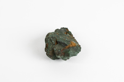 A hand-sized solid mineral specimen in shades of blue, green and copper.